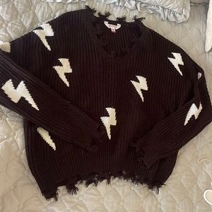 Black pull over sweater with white lightening bolts. Never worn